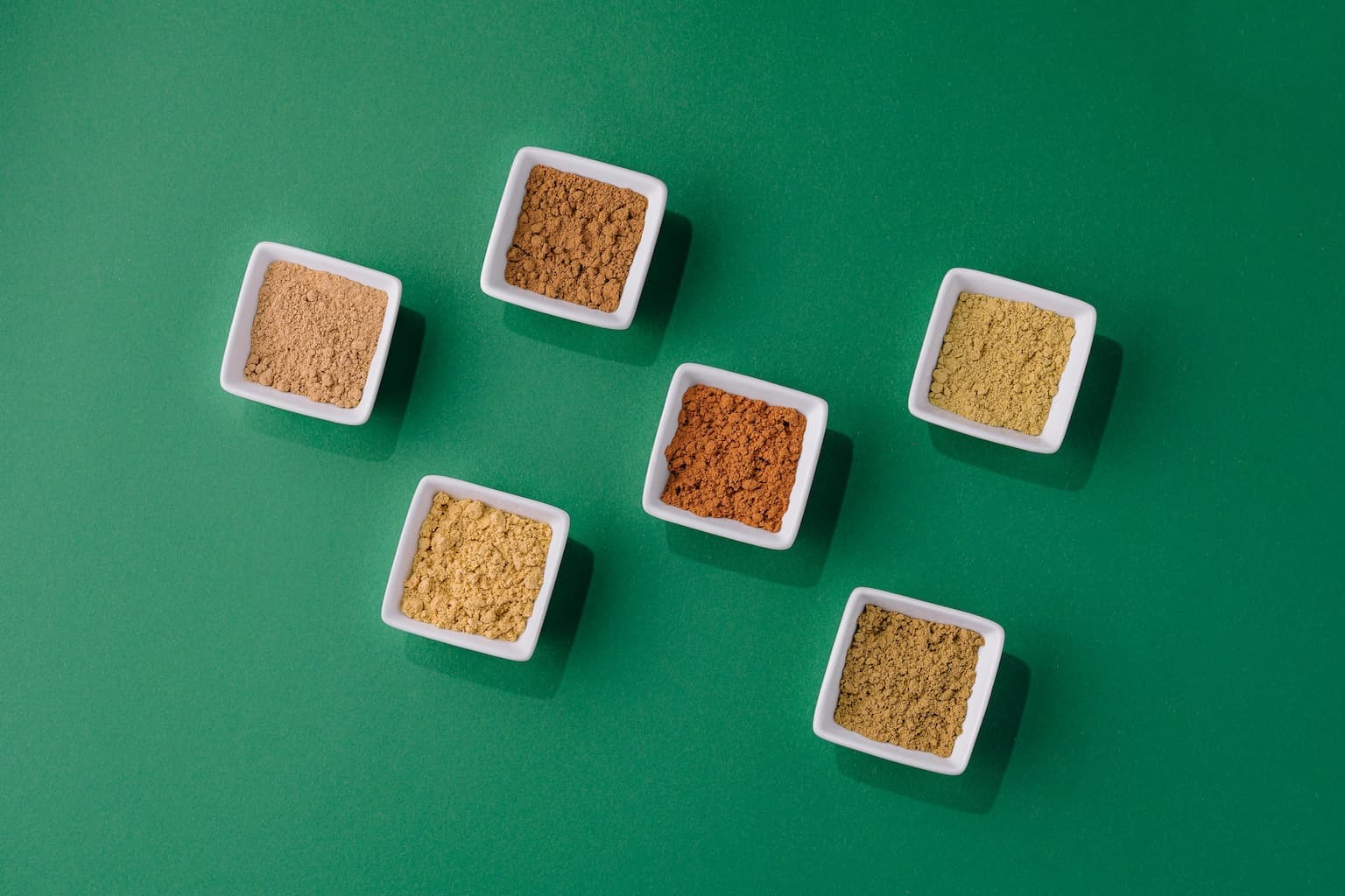 Various seed flours in white dishes